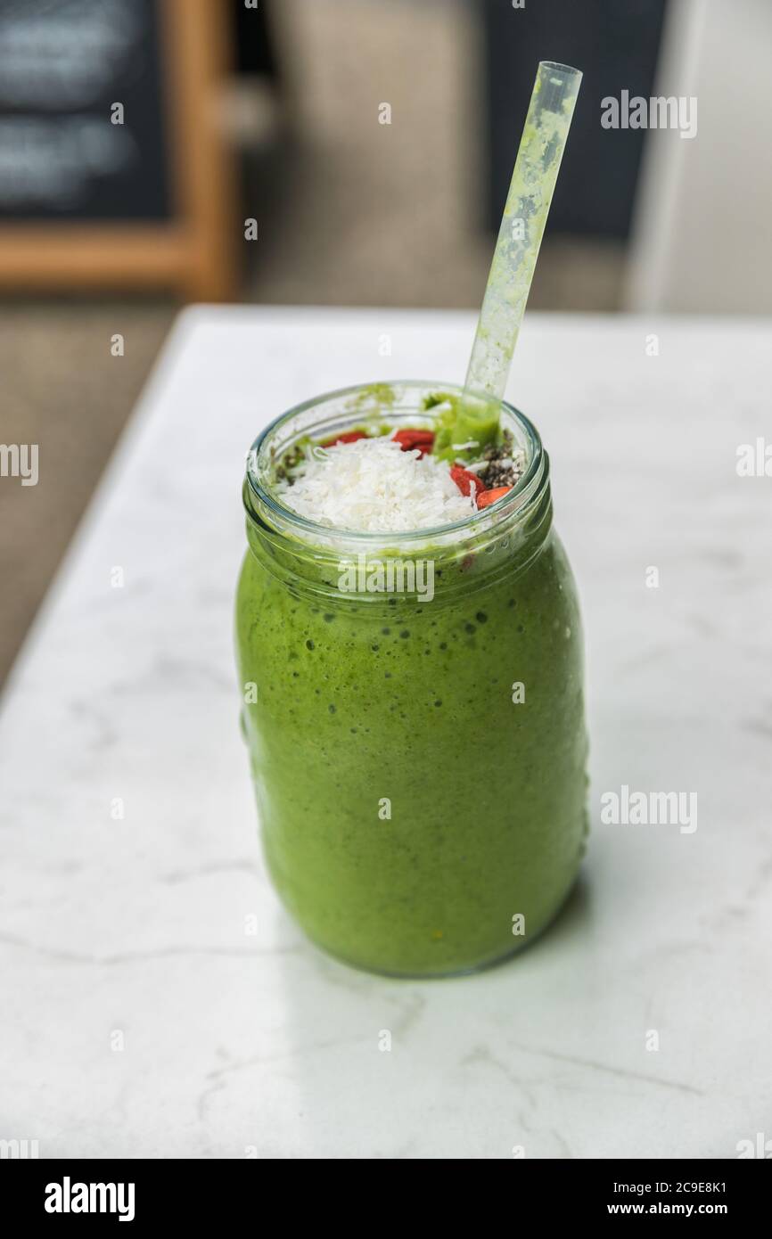 Green smoothie detox cleanse drink at cafe restaurant morning breakfast meal replacement for weight loss diet. Healthy eating lifestyle. Stock Photo