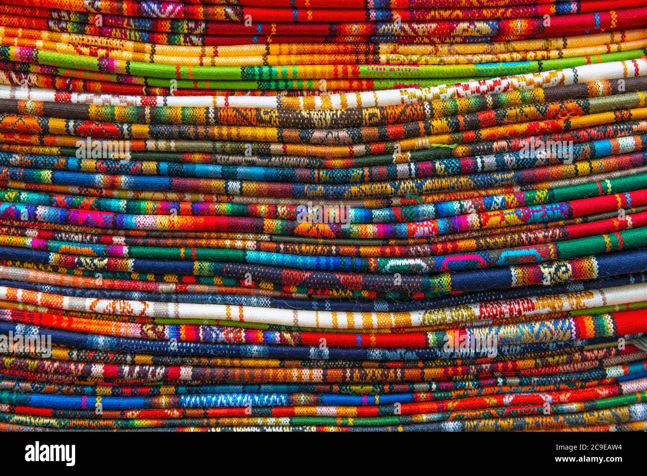 A stack of Andes Textiles on a local handicraft market, Cusco, Peru. Stock Photo