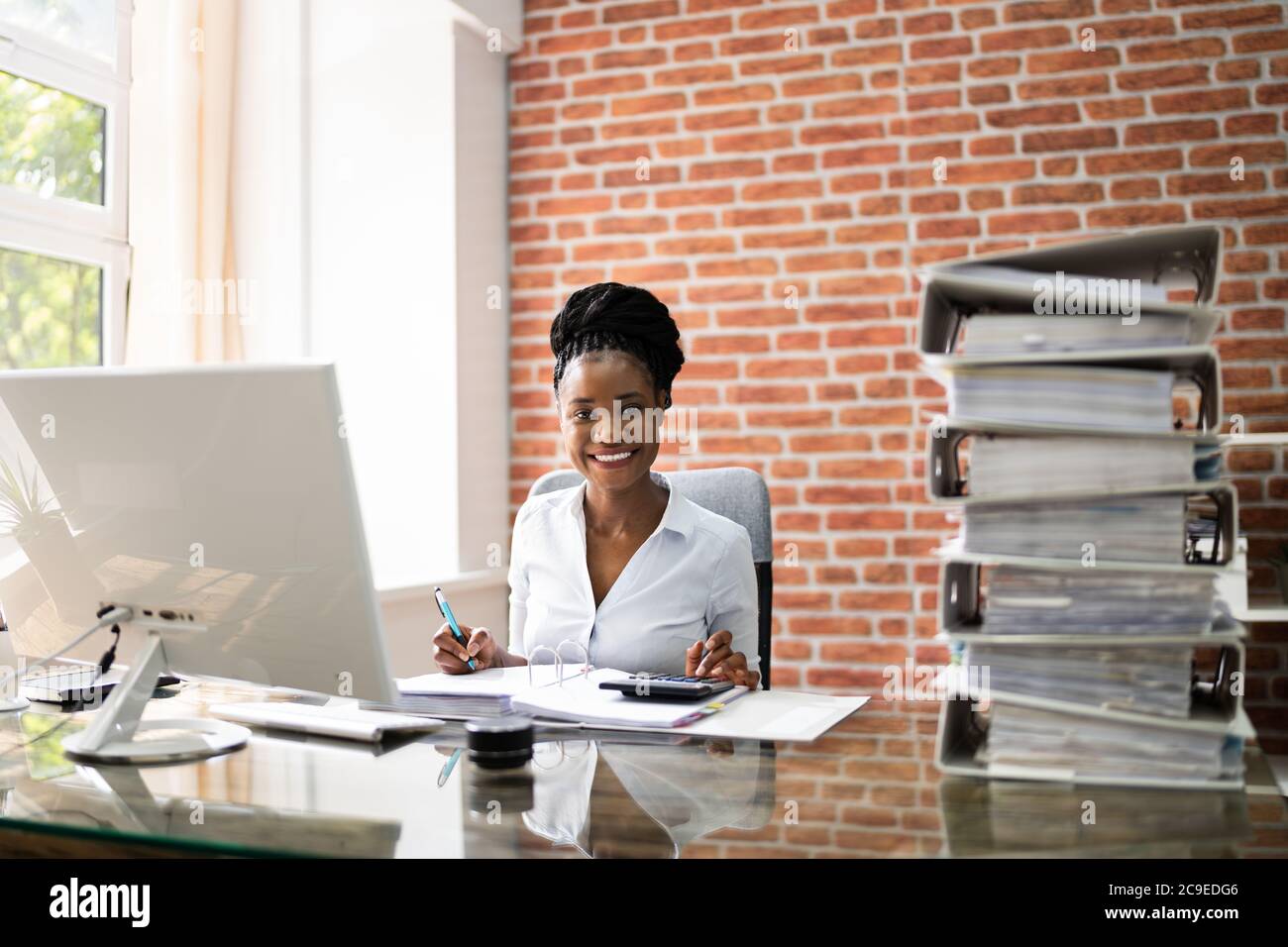 Business Woman Reviewing Files Doing Too Much Stock Photo