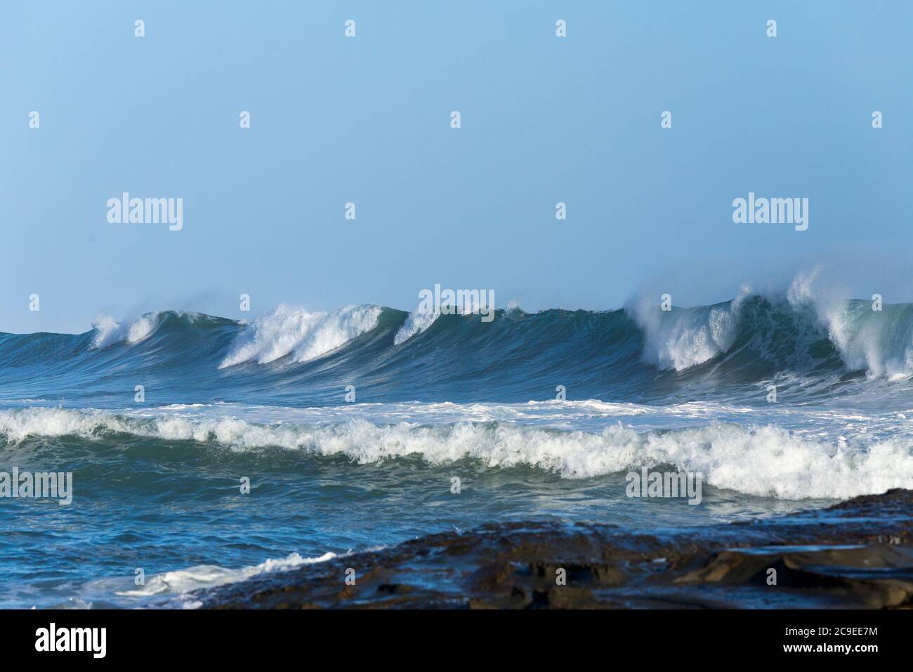 Crashing waves breaking on beach at Marengo Point in Apollo Bay Australia on a summer day Stock Photo