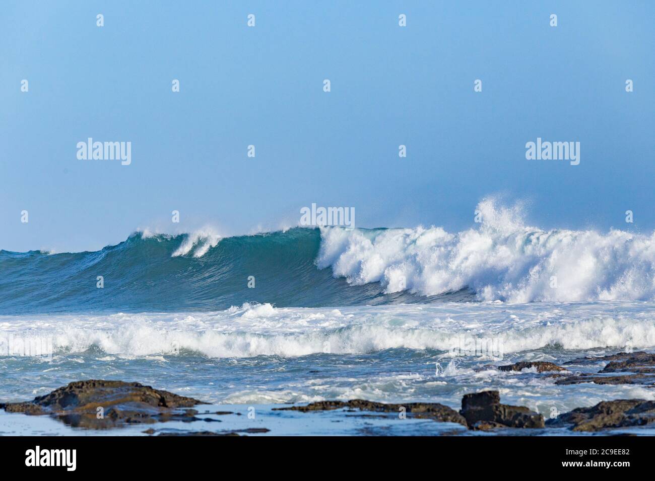 Crashing waves breaking on beach at Marengo Point in Apollo Bay Australia on a summer day Stock Photo