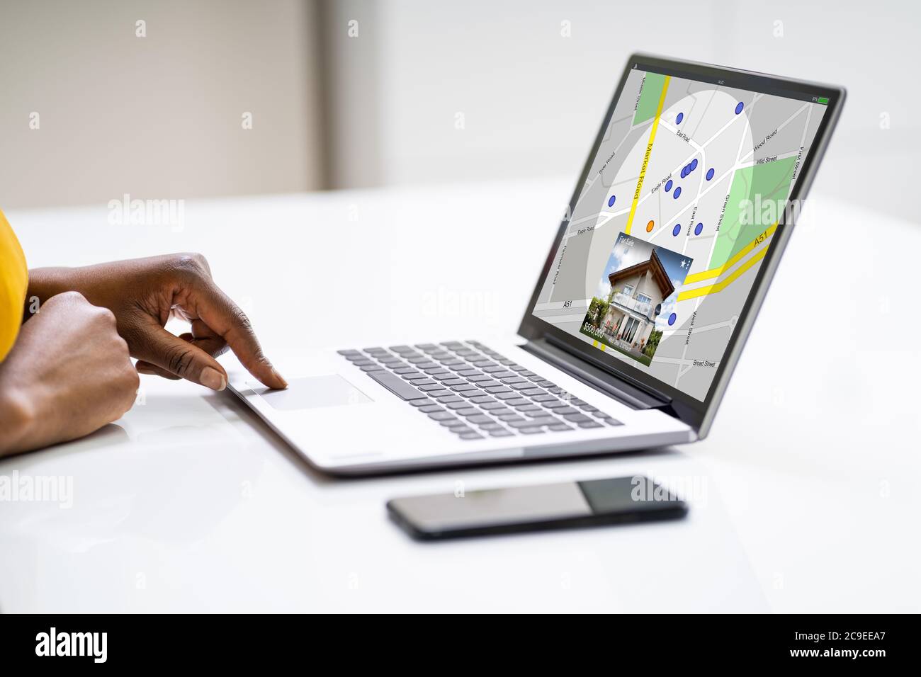African American Woman Using Real Estate Map On Laptop Computer Stock Photo