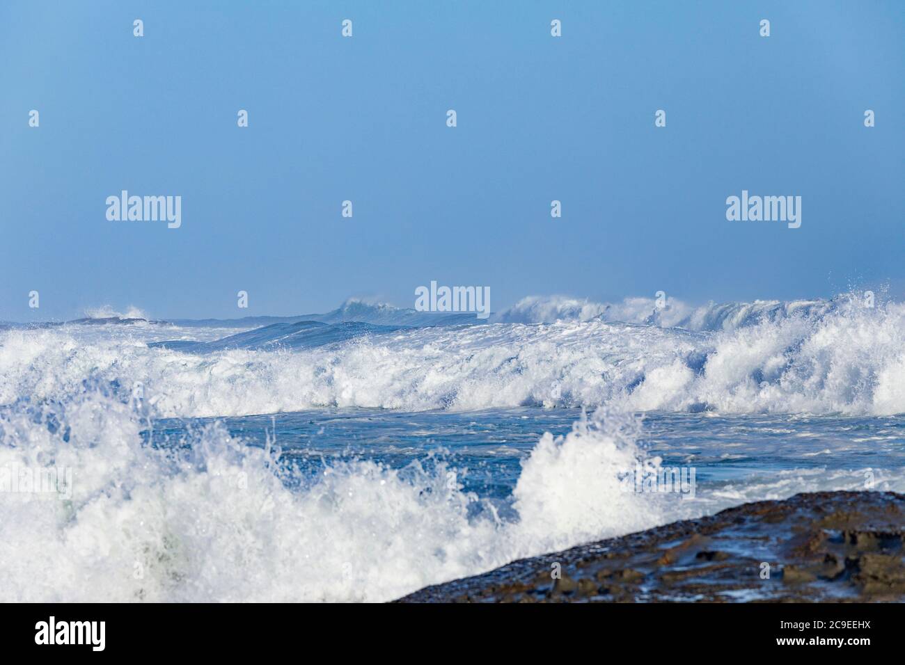 Crashing waves breaking on beach at Marengo Point in Apollo Bay Australia on a summer day Stock Photo