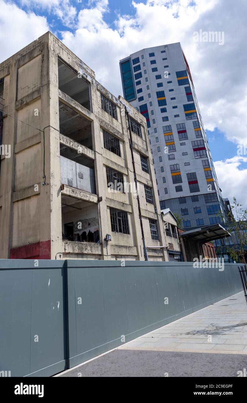 Contrast derelict industrial building modern housing development high