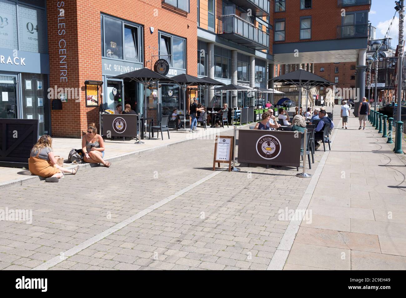 People sitting outside newly reopened cafes on the waterfront, Wet Dock, Ipswich, Suffolk, England, UK July 2020 Stock Photo
