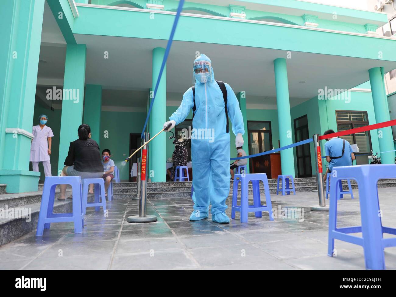 Hanoi, Vietnam. 30th July, 2020. A staff member disinfects at a health station in Hanoi, Vietnam, July 30, 2020. Vietnam recorded 45 new domestically transmitted COVID-19 cases on Friday morning, bringing its total confirmed cases to 509, according to its Ministry of Health. Credit: Handout By VNA/Xinhua/Alamy Live News Stock Photo