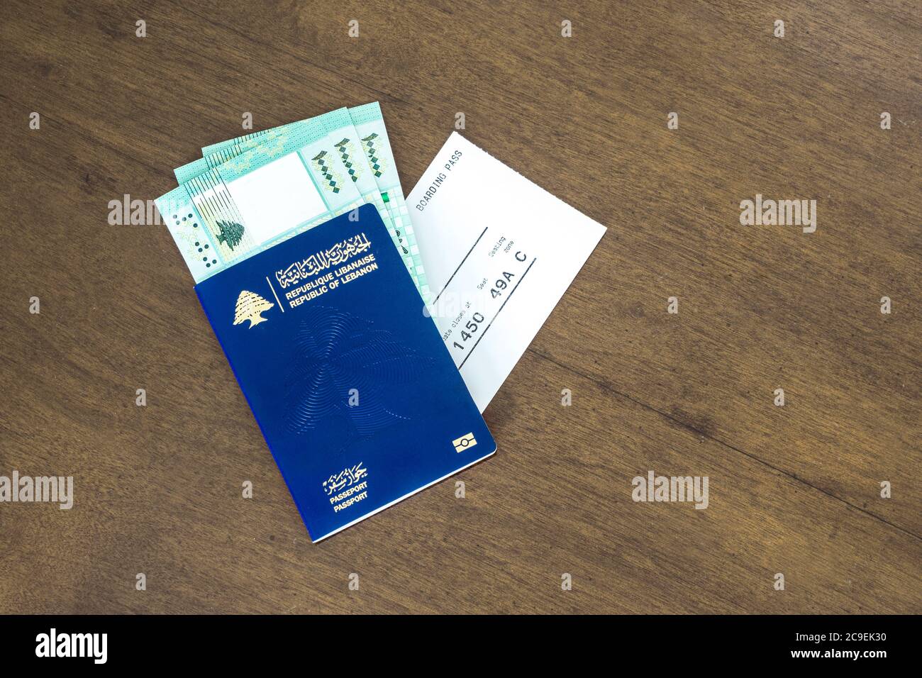 Lebanese passport with Lebanese pounds bills and boarding pass Stock Photo