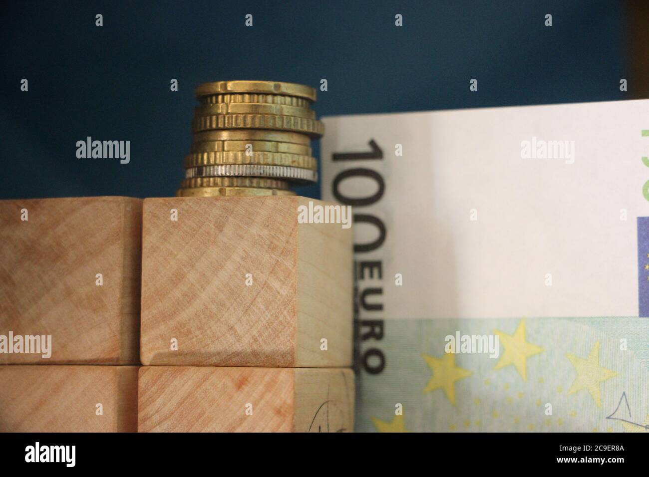 Stack of Euro coins and 100 Euro bill. Business profit concept Stock Photo