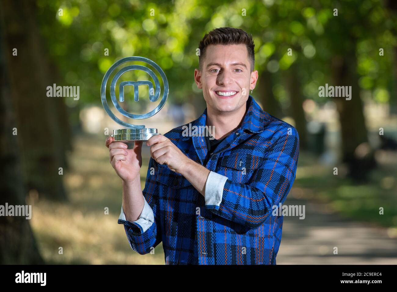 Riyadh Khalaf the winner of Celebrity MasterChef with his trophy. The Irish-Iraqi broadcaster and internet personality fought off competition from 19 other famous faces during the 2020 edition of the BBC One series. Stock Photo