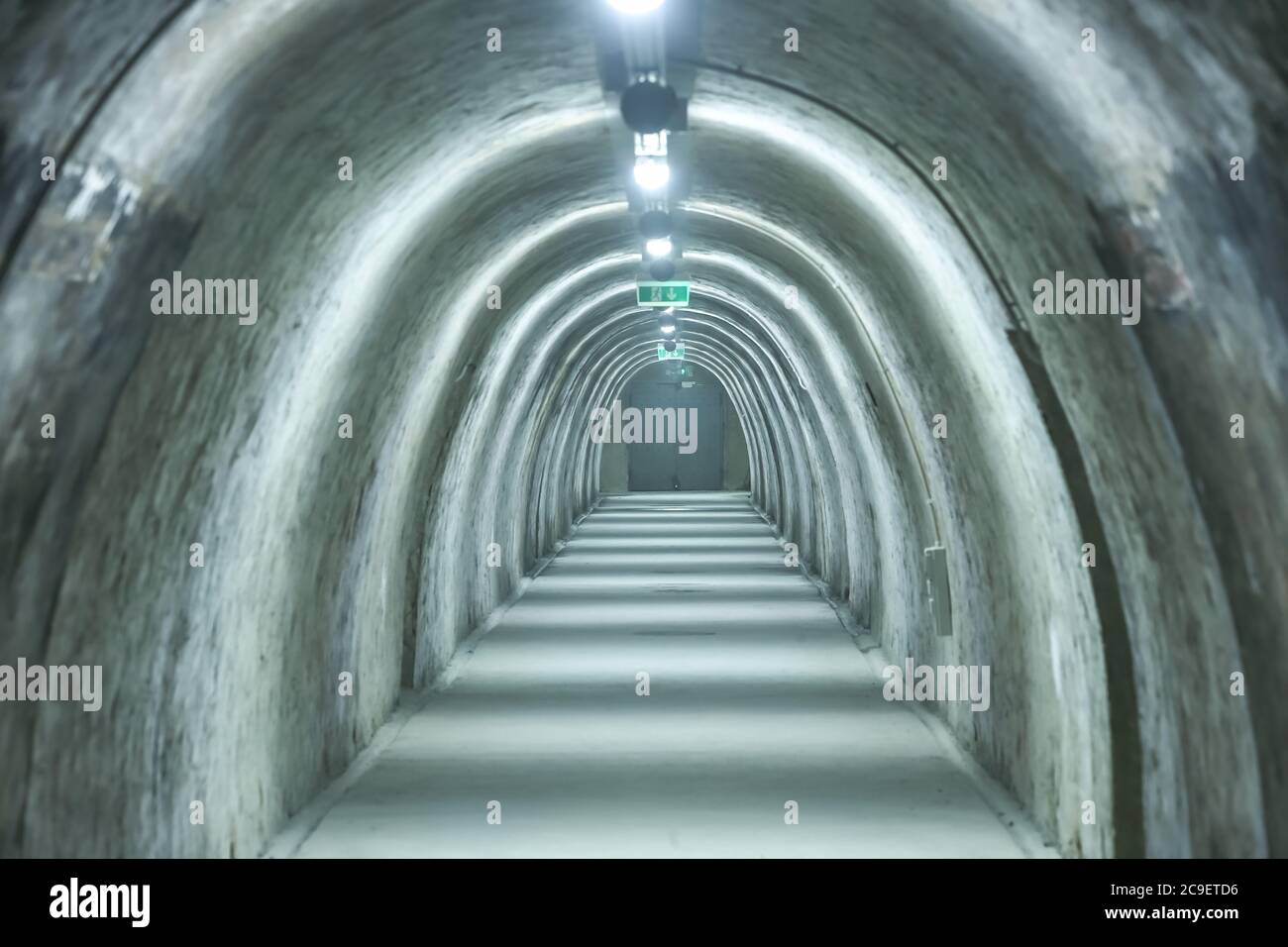 Old concrete tunnel with fluorescent lights. Stock Photo