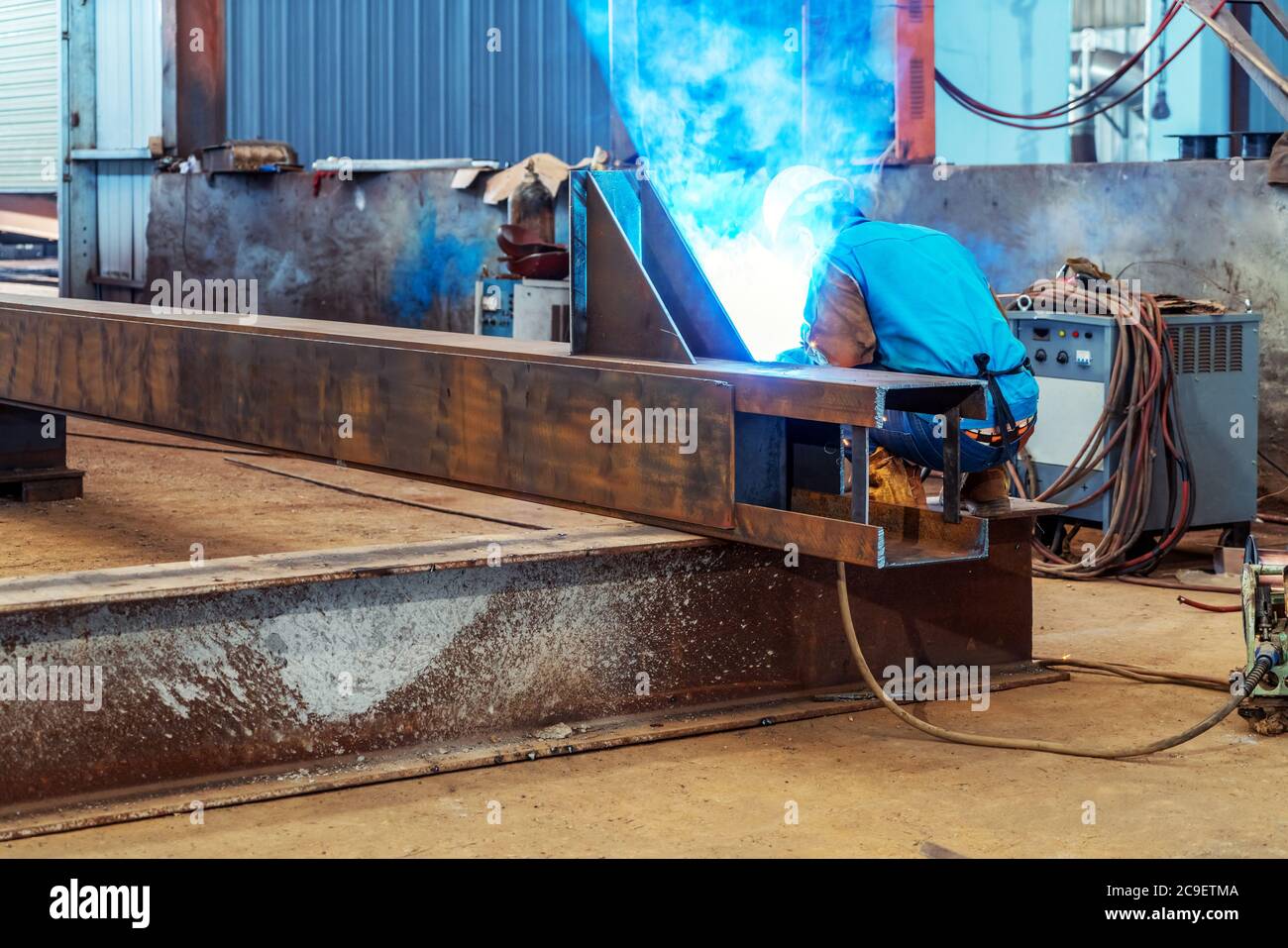 Workers at work, ongoing welding operation. Stock Photo