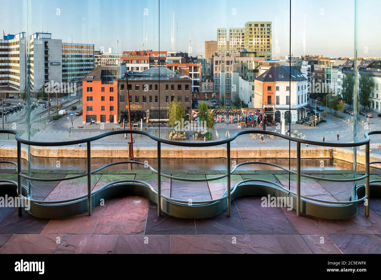 View through the curved windows of the modern MAS museum on the surrounding cafes and restaurants Stock Photo