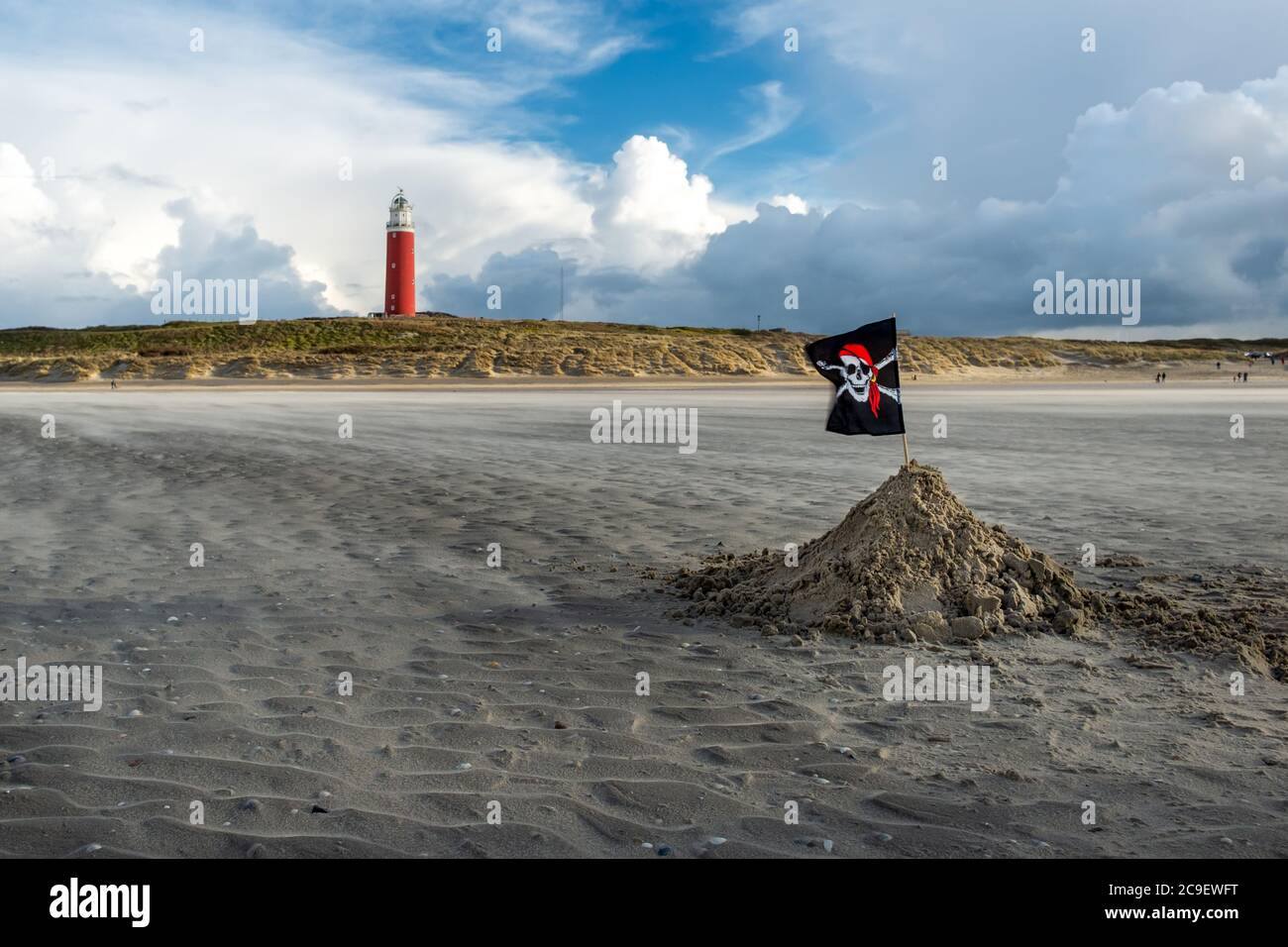 Pirate flag and lighthouse on the windswept beaches of Texel Stock Photo