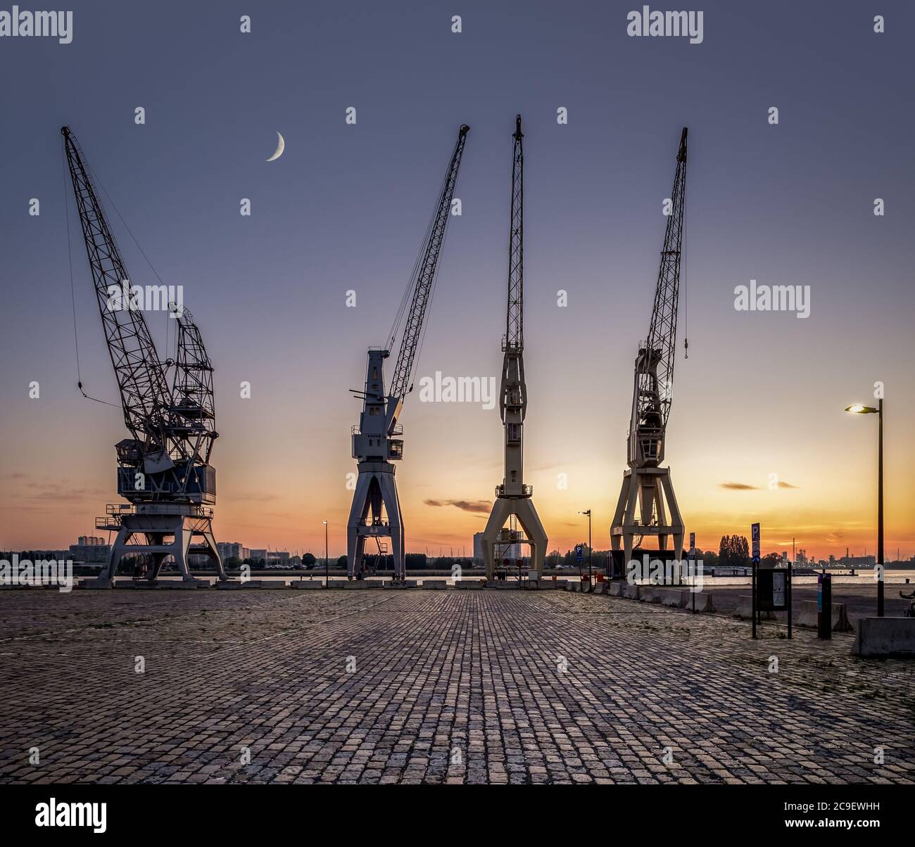 A row of 4 old harbor cranes in the city of Antwerp. Stock Photo