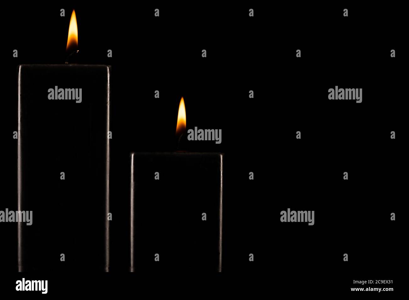 Burning black candle on dark Stock Photo Alamy