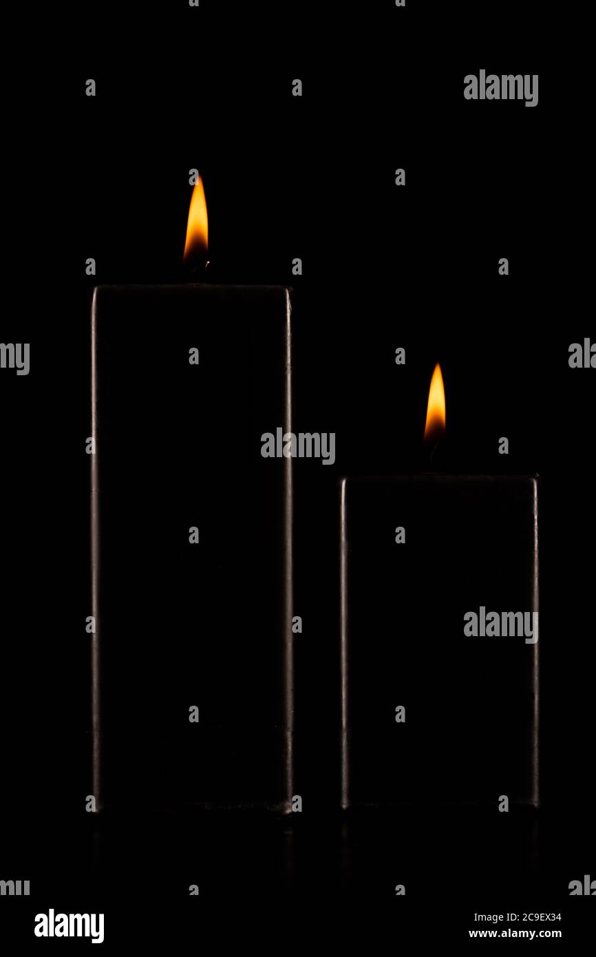 Burning black candle on dark Stock Photo Alamy