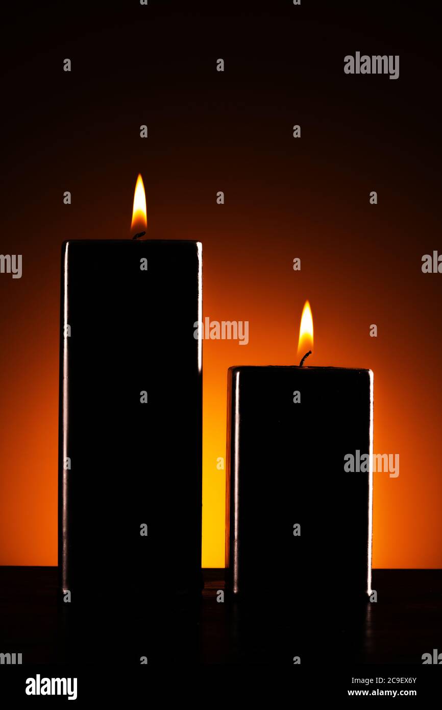 Burning black candle on dark Stock Photo Alamy
