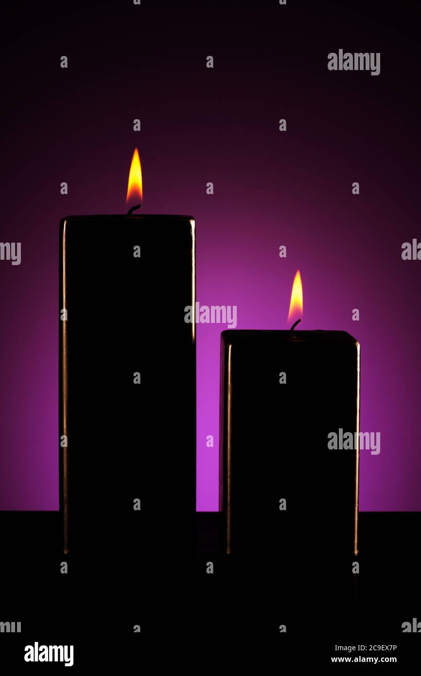Burning black candle on dark Stock Photo Alamy