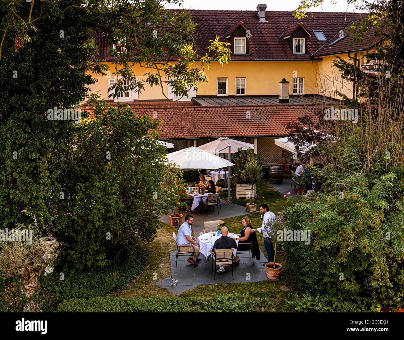 Outdoor catering in Hotel Mühle in Binzen, Germany. Idyllic garden with space for seating groups. Discreet transformation to more Italian Dolce Vita are planned in the Hotel Mühle and Restaurant La Cucina Stock Photo