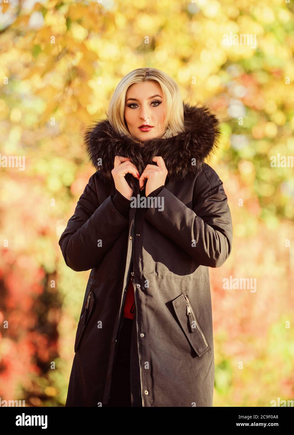 Girl wear parka while walk park. Autumn season fashion concept. Puffer jacket with hood. Woman wear black parka fur hood. Classic parka coat has Stock Photo Alamy
