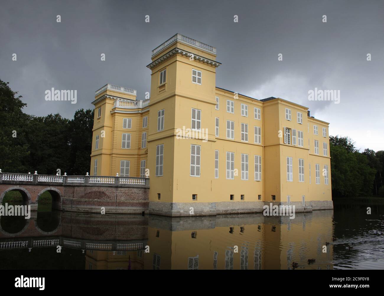 HINGENE, BELGIUM, 16 JULY 2020: The beautiful water surrounded d'Ursel Castle in Hingene. The castle provides the backdrop for the biennial 'Castle Fe Stock Photo