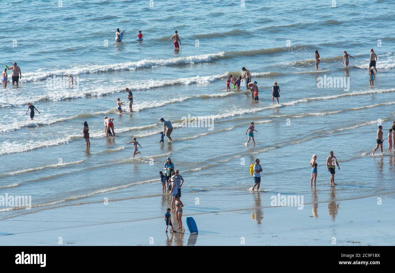 Lyme Regis, Dorset, UK. 31st July, 2020. UK Weather: Holidaymakers and sunbathers flock to the seaside resort of Lyme Regis to soak up the scorching hot sunshine on the hottest day of the year so far. People were already overheating and ready for a dip in the sea at 10am. Credit: Celia McMahon/Alamy Live News Stock Photo