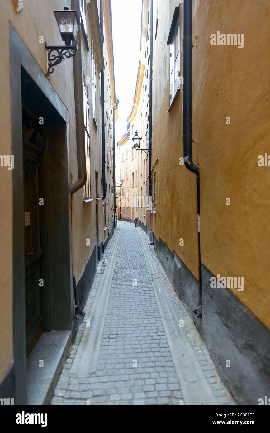 Empty narrow alley of yellow vintage buildings in Sweden Stock Photo