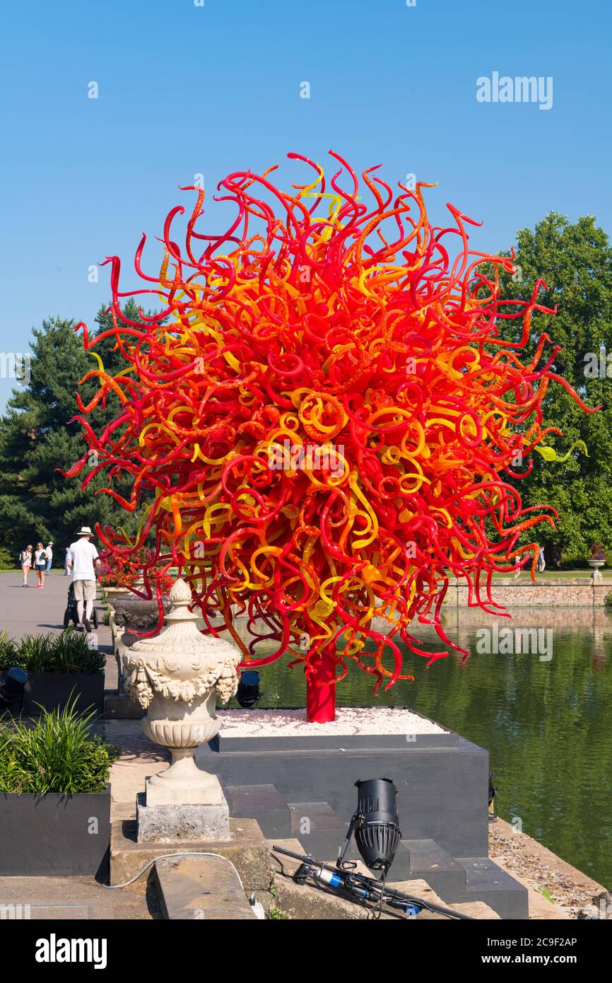 Kew Royal Botanical Gardens iconic Dale Chihuly Reflections Exhibition colourful glass sculptures sculpture art Summer Sun lake people reflection Stock Photo