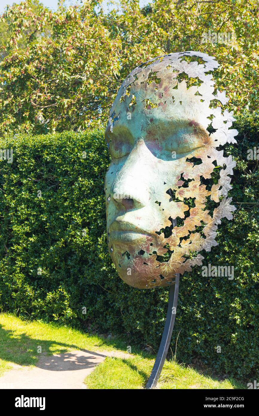 Kew Royal Botanical Gardens iconic Dale Chihuly Reflections Exhibition colourful glass sculptures sculpture art large face mask leaf motif Stock Photo