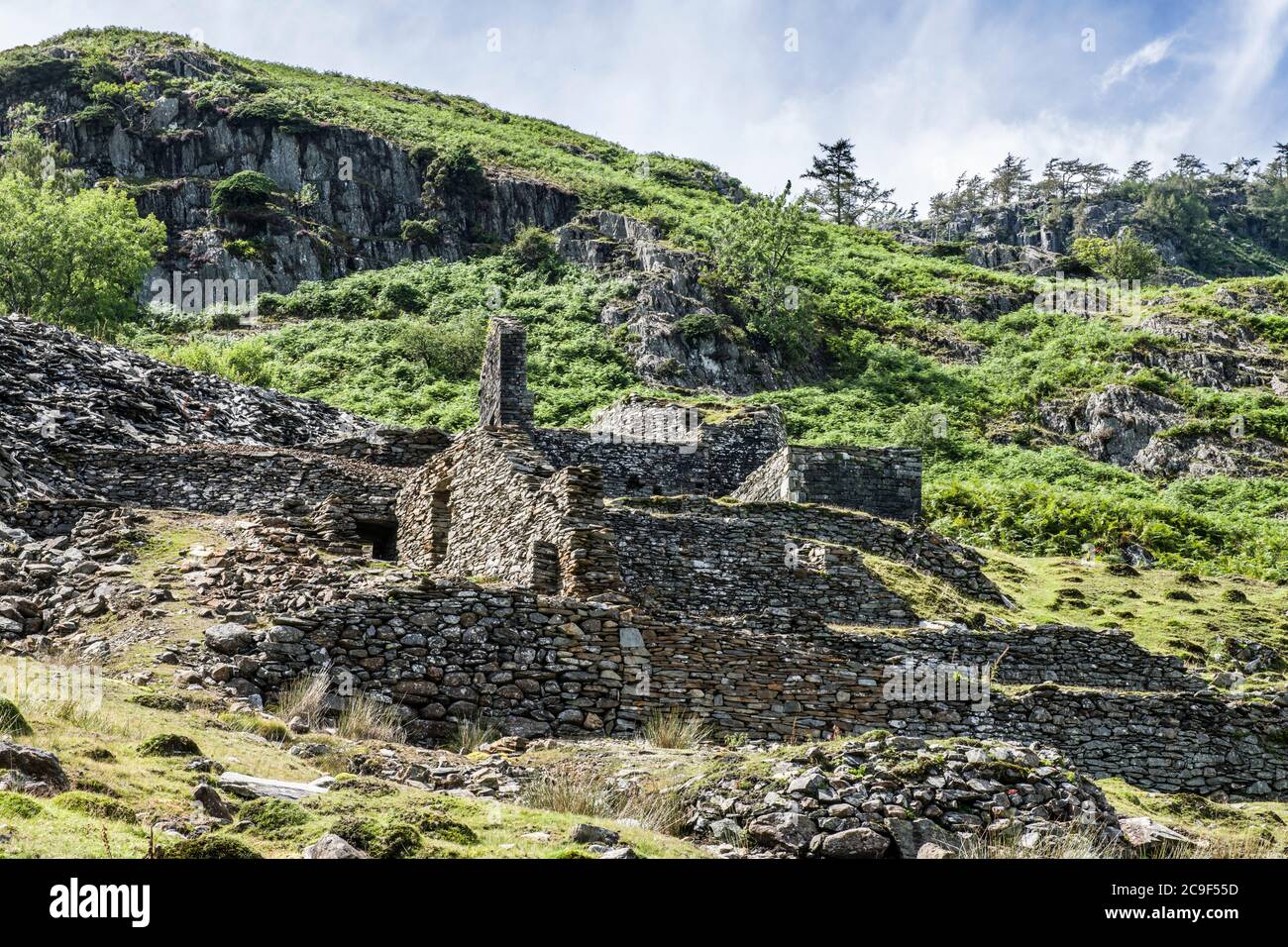 Ruins of old slate quarry buildings at Tilberthwaite in the Lake District National Park, Cumbria, on a sunny summer day in July. Stock Photo