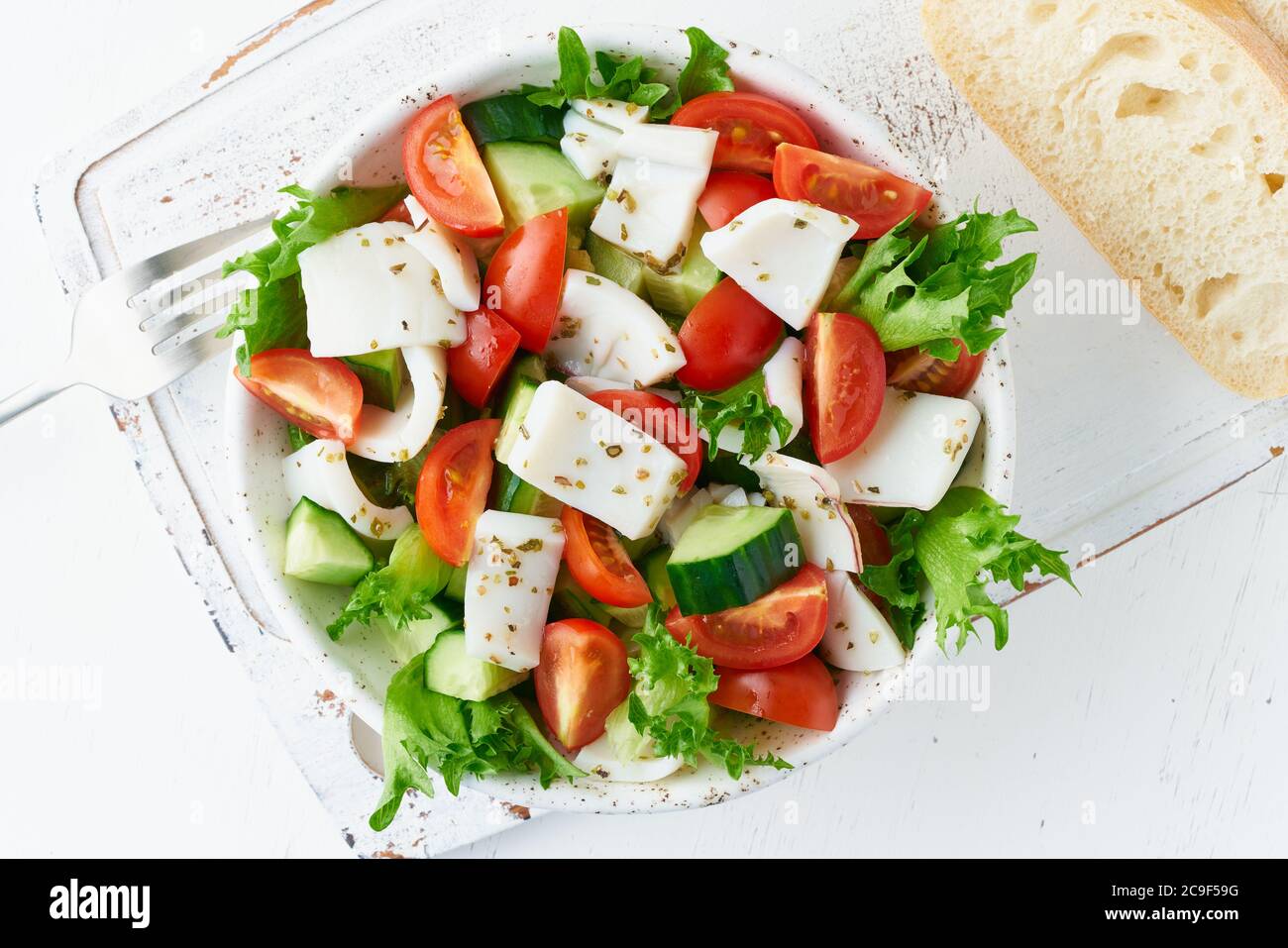 Salad with squid, cucumbers, tomatoes, lettuce. LCHF, FODMAP, paleo