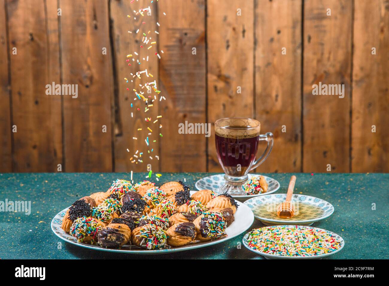Butter biscuits with falling colored sprinkles Stock Photo Alamy