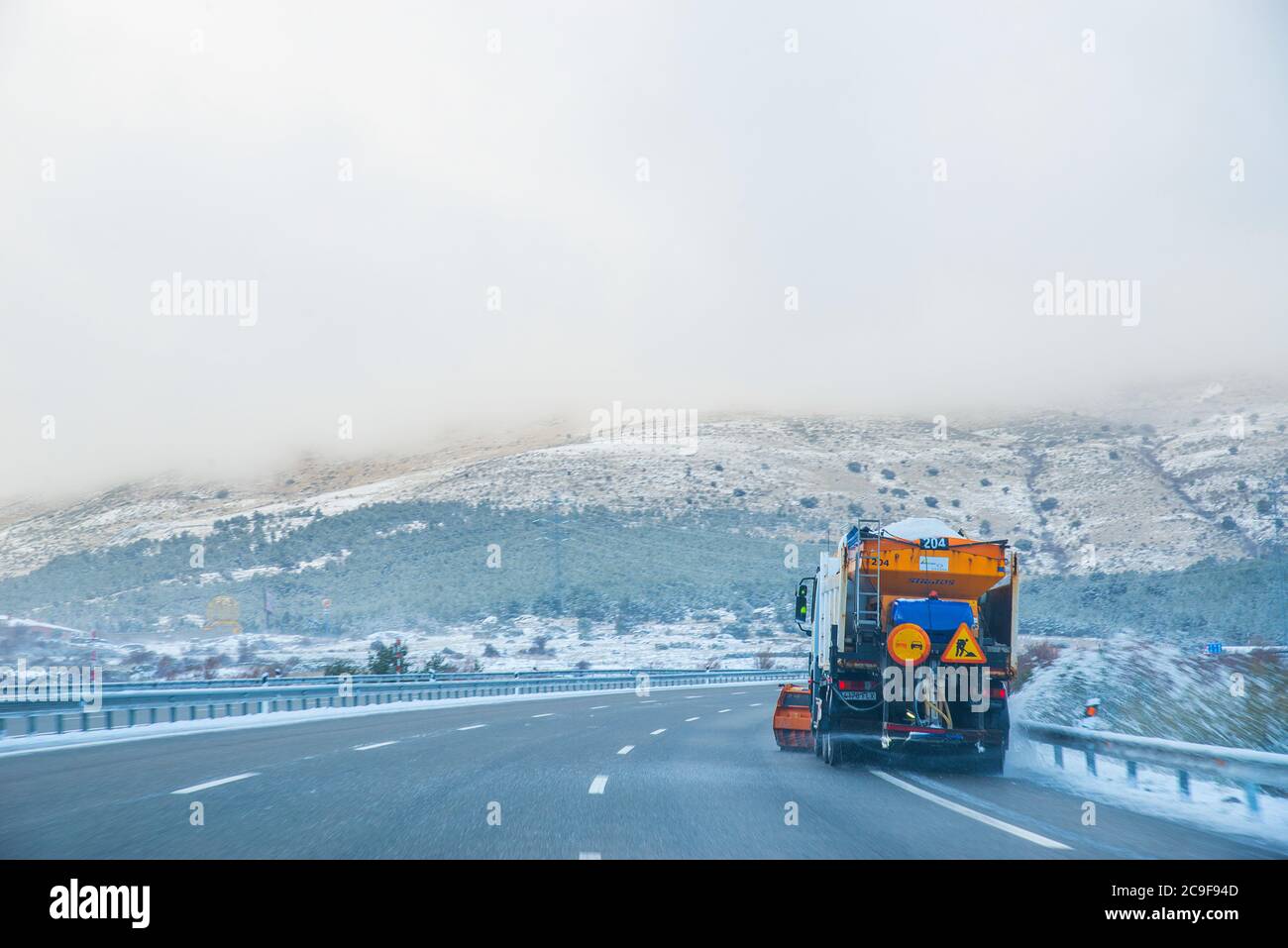 Snowplough working in highway. Stock Photo