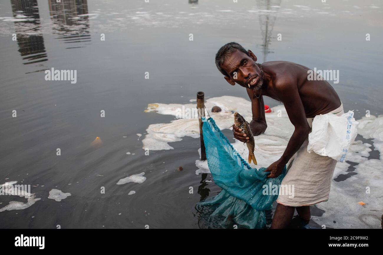 July 30, 2020, New Delhi, New Delhi, India: Indian fishermen use a fishing  net in the polluted water of the Yamuna river on July 30, 2020 in New  Delhi, India. As governments