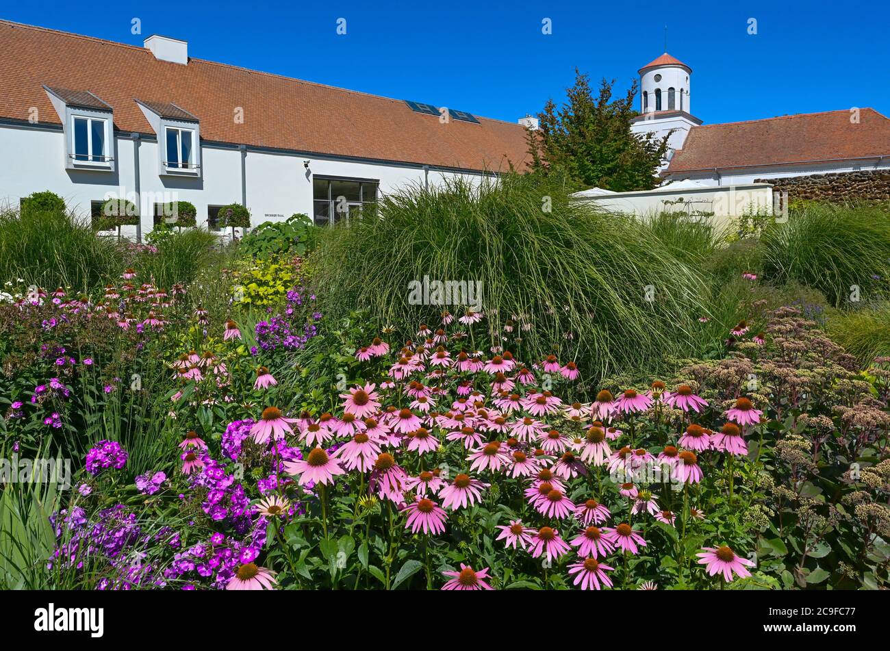 Neuhardenberg Germany 31st July Flowers Blossom In The Garden Of The Schloss Neuhardenberg Foundation In The Background The Tower Of The Schinkel Church Rises Into The Blue Sky After The Pandemic Related