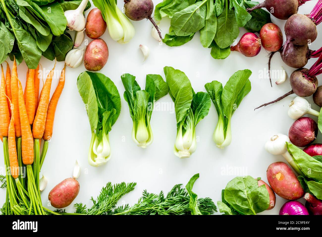 Carrot Potato Beet Onion And Spinach On White Background Top View Carrot Potato Beet Onion And Spinach On White Background Top View