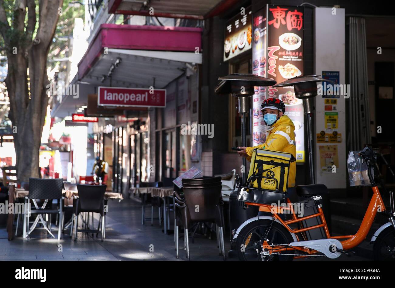 Sydney, Australia. 29th July, 2020. A delivery man waits outside a restaurant in Chinatown of Sydney, Australia, on July 29, 2020. Now, with record COVID-19 cases in the city of Melbourne and Sydney being potentially on the brink of a second wave, restaurants and bars are preparing to be hit with a return to lockdown as they struggle to survive. TO GO WITH 'Feature: Sydney's iconic Chinatown eateries adapt to life under COVID-19' Credit: Bai Xuefei/Xinhua/Alamy Live News Stock Photo