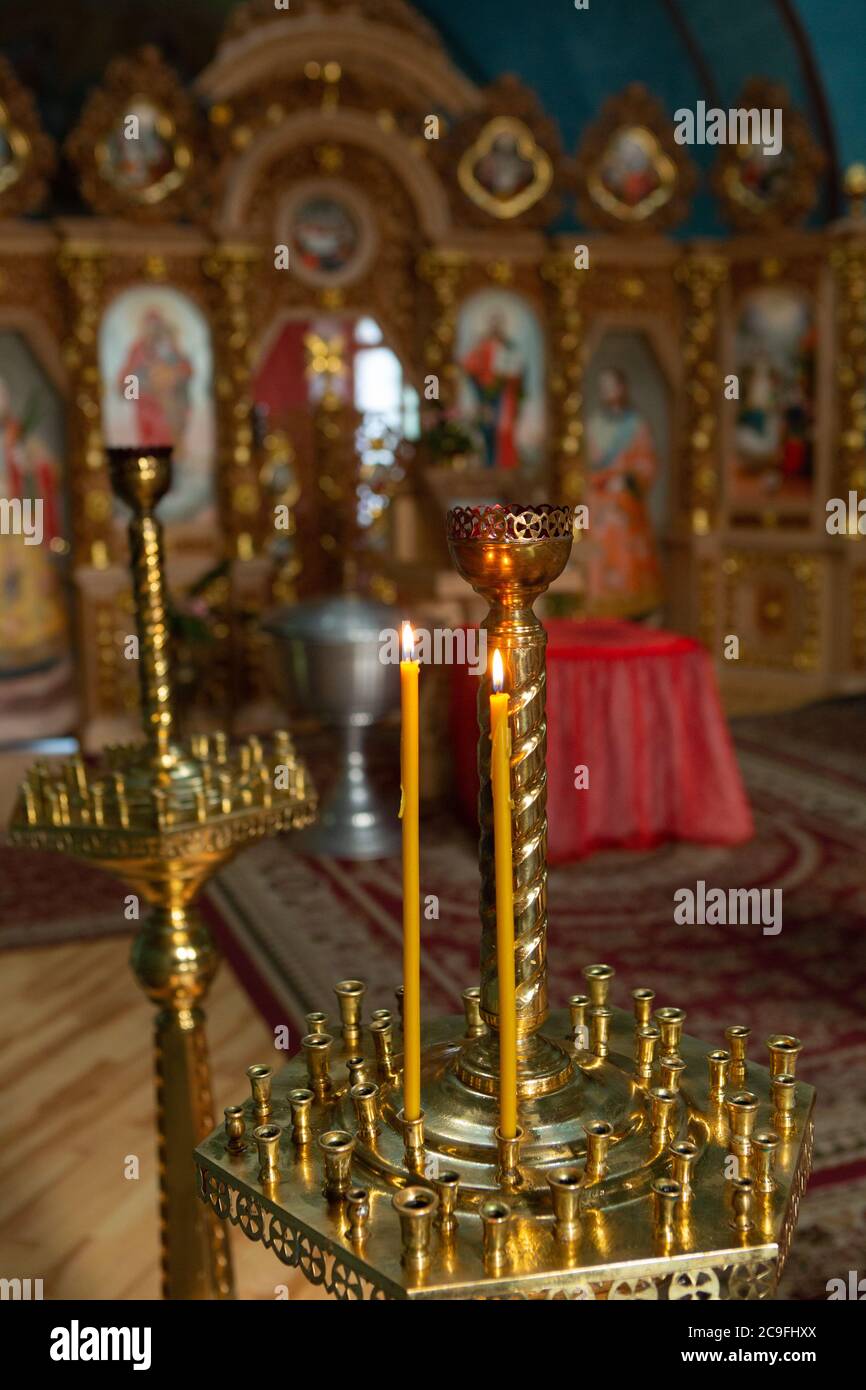 Burning candles in church Interior. Close up shot. Religion concept. St
