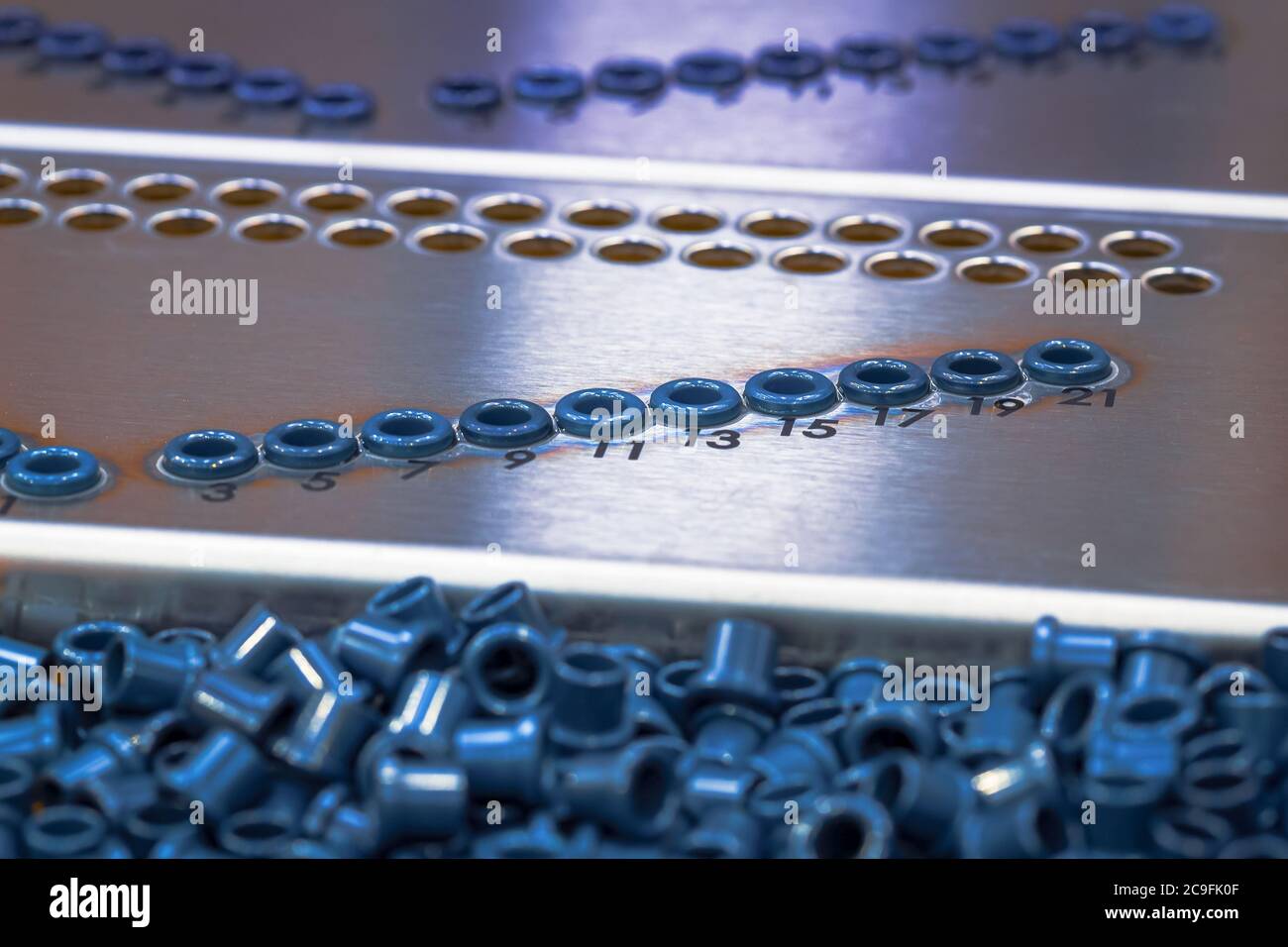 Ceramic Eyelets bonded to stainless steel panel Stock Photo