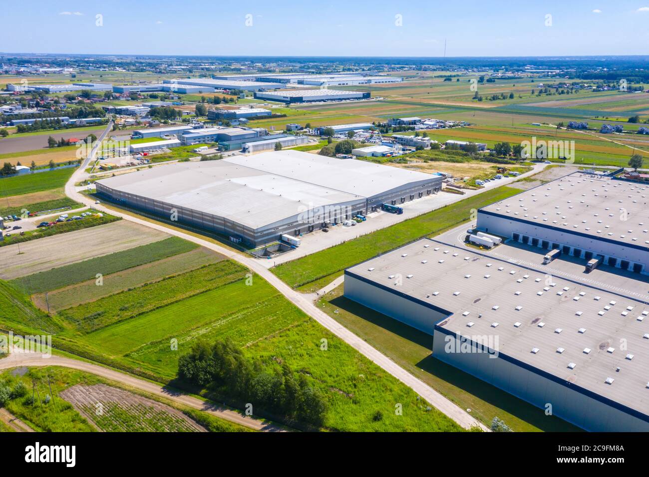 Aerial Shot of Industrial Warehouse Loading Dock where Many Truck with ...