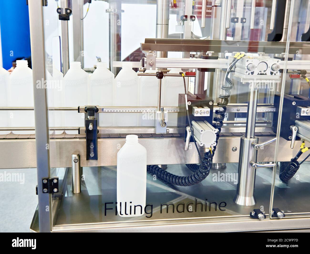 Plastic bottles in filling machine on fabric Stock Photo