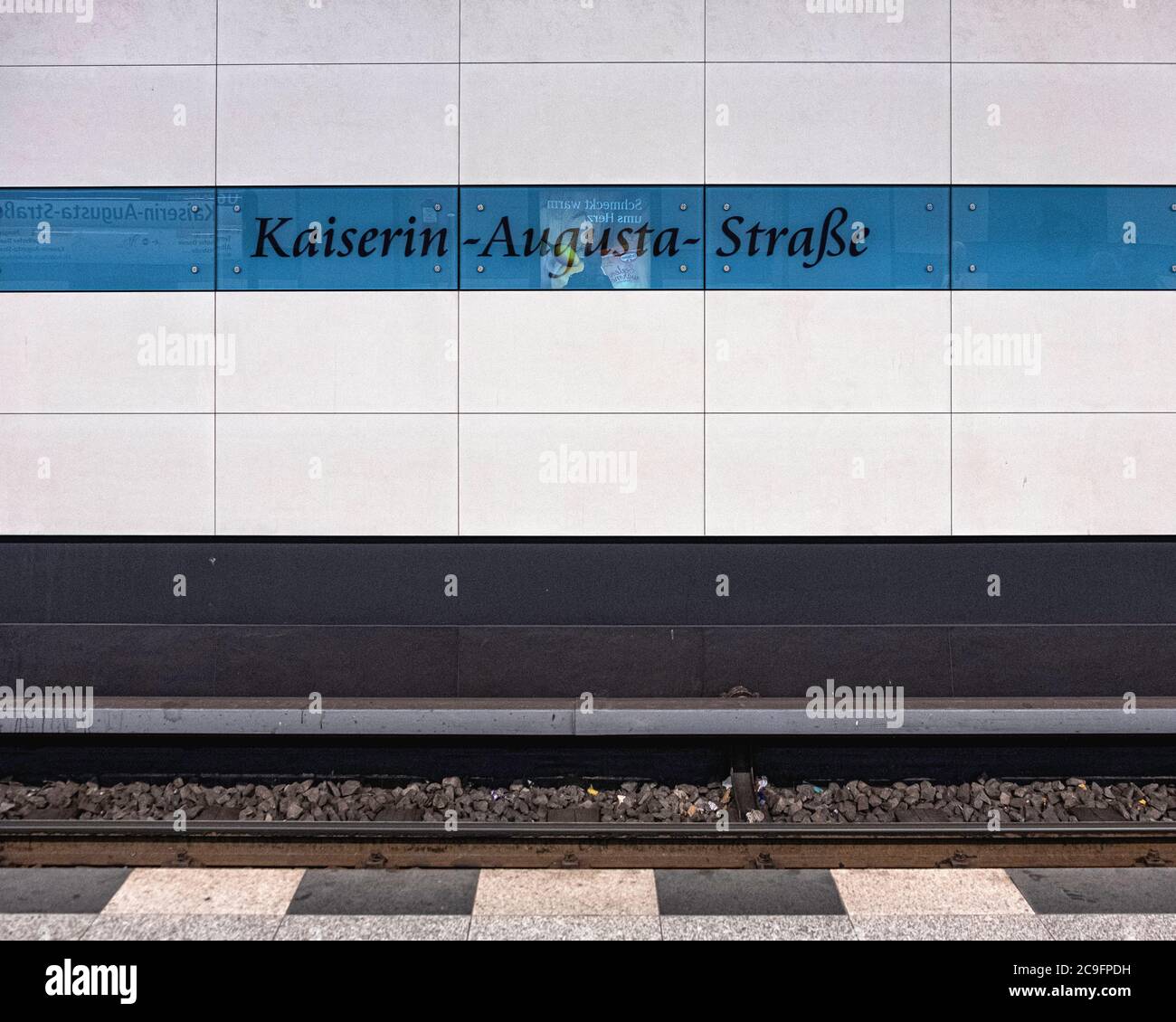 The Kaiserin-Augusta-Strasse U-Bahn underground railway station interior on the U6 line in Tempelhof-Berlin.Blue & white tiled wall with station name Stock Photo