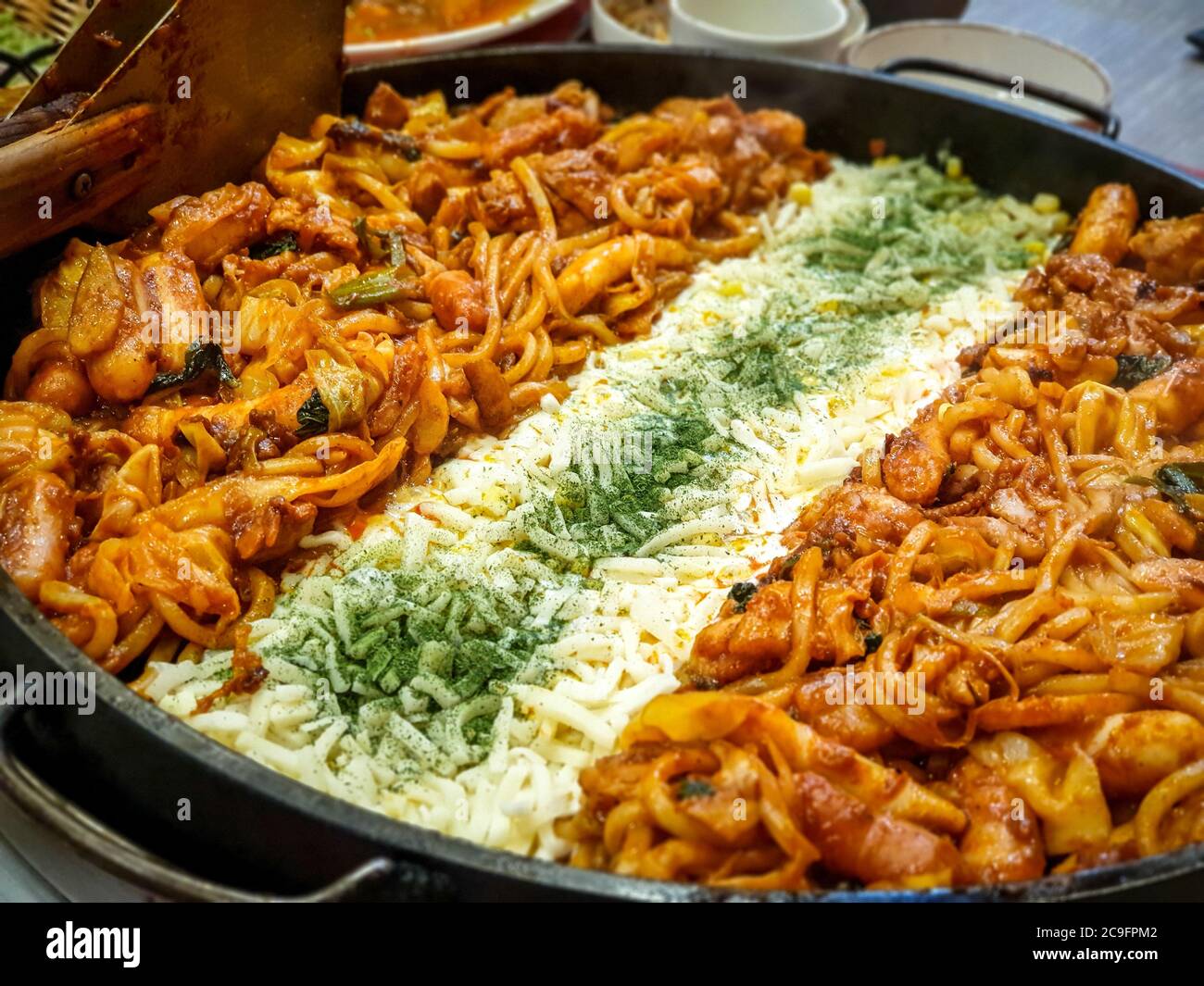 Cheese Dak-galbi, spicy stir-fried chicken rib, vegetable, noodle and cheese on grill - South Korea. Popular Korean food among foreign tourists. Stock Photo