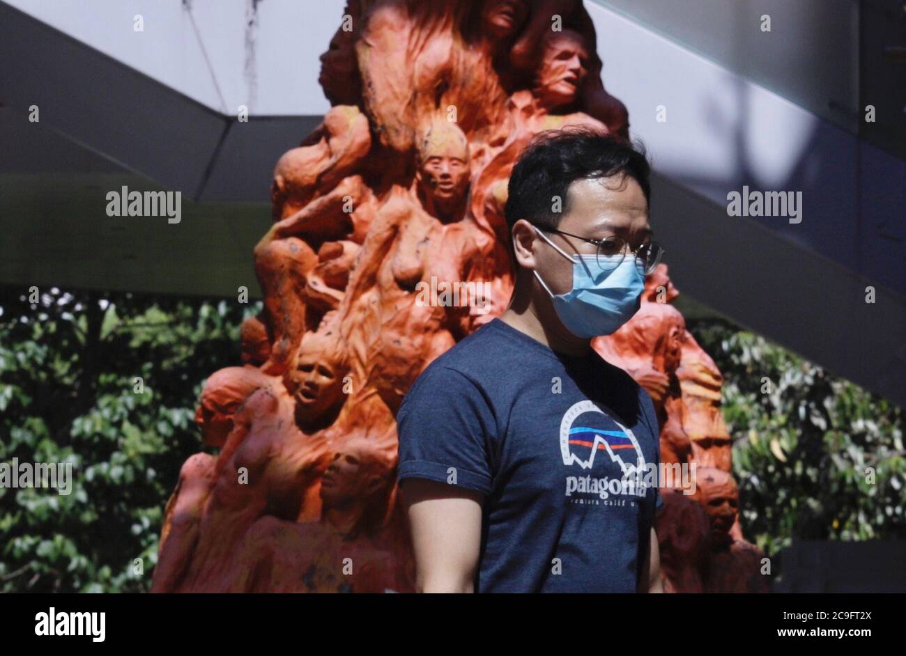 Hong Kong, CHINA. 30th July, 2020. Student walk past PILLAR OF SHAME, a  sculpture work by Danish artist Jens Galschiot to commemorate victims of  the 1989 June-4th Tian An Men Massacre displayed