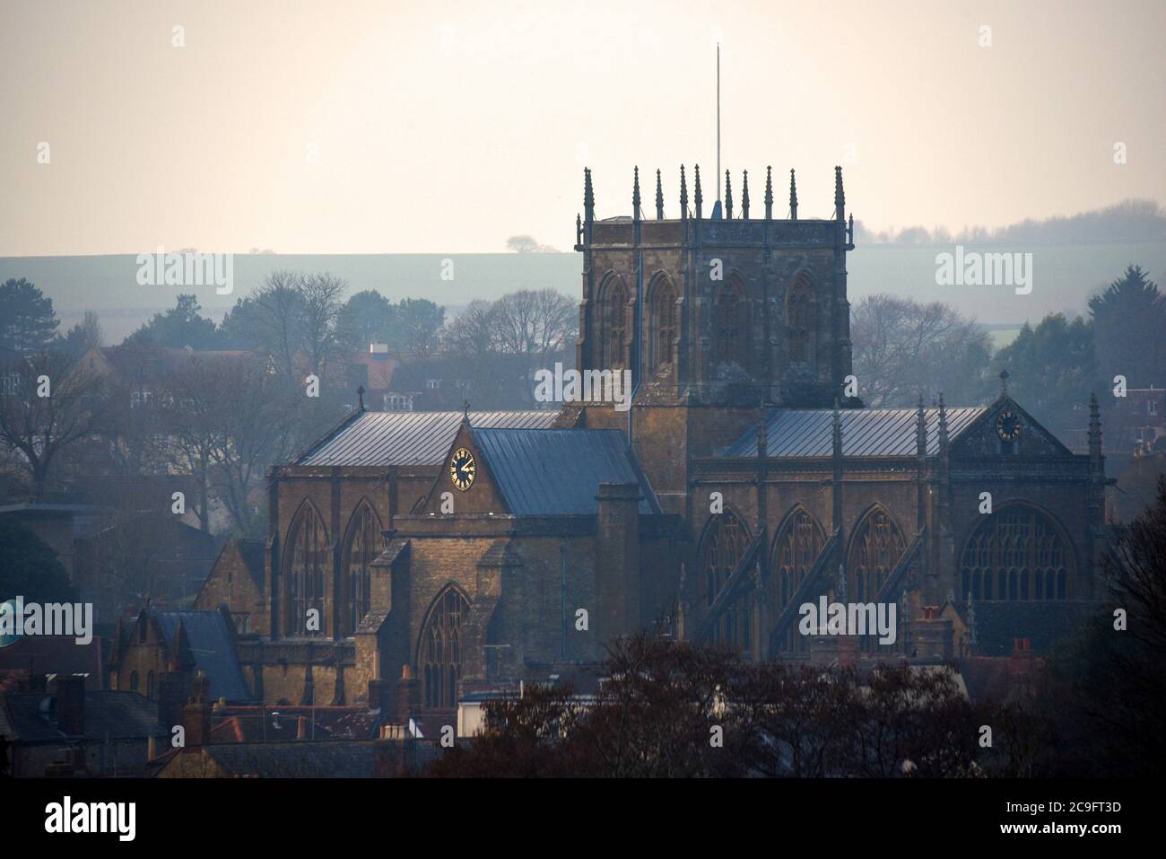 Beautiful Sherborne Abbey in Dorset stands out as the mist clears on a morning in February Stock Photo