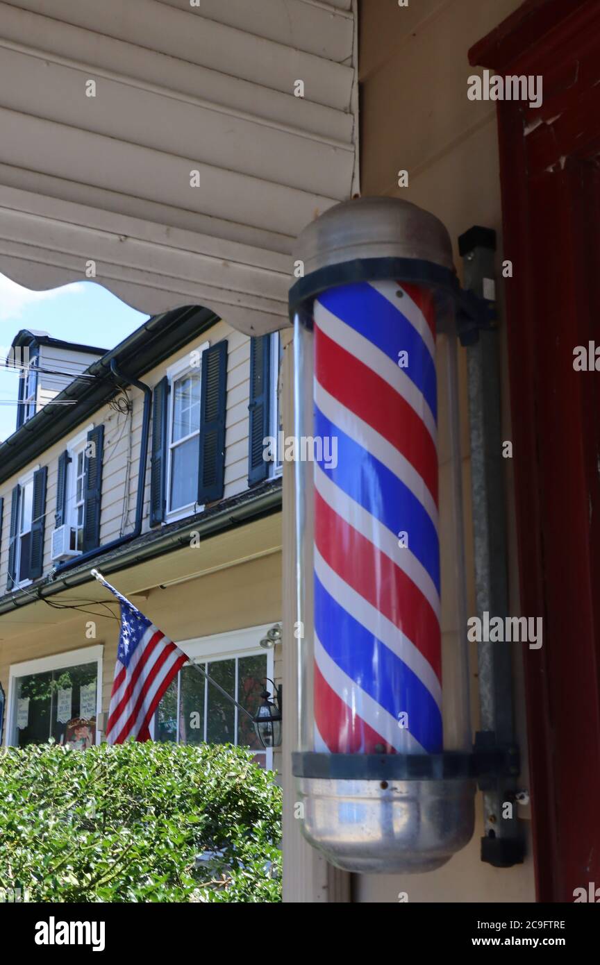 Barber poles are red, white, and blue and a tradition in the United States. Stock Photo