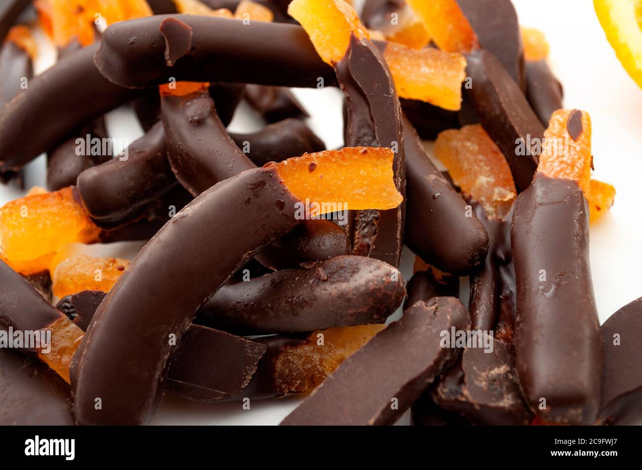 Seasonal candies and sweets,citrus fruit dipped in chocolate and homemade sweet treat concept with close up on candied orange peel Stock Photo