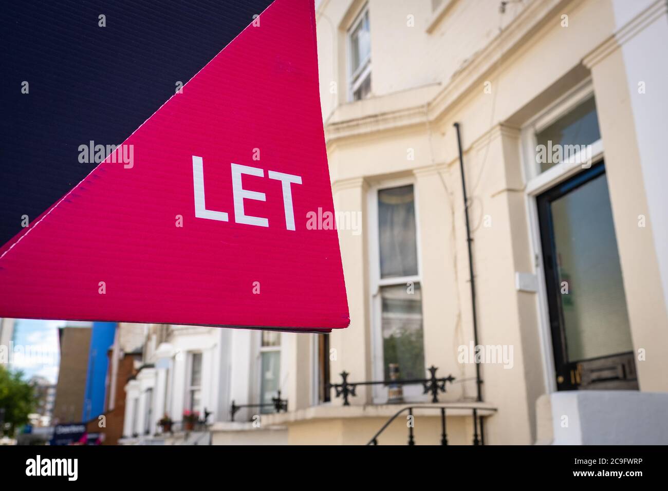 Estate agency 'To Let' sign board on street of British houses with ...