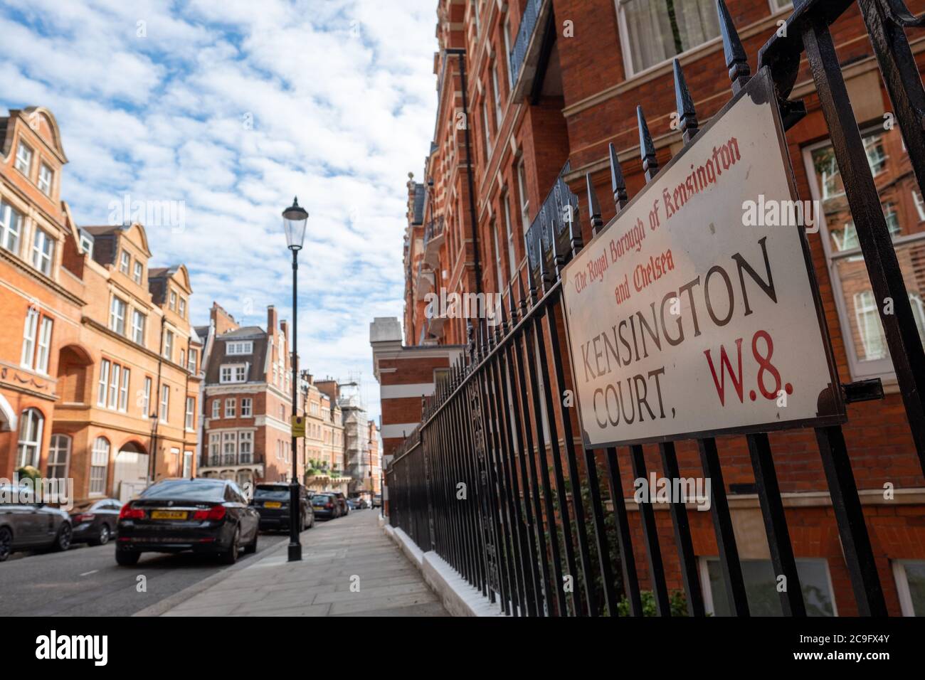 London, July, 2020: Residential street of beautiful red brick terraced London townhouses in Kensington Court, west London Stock Photo