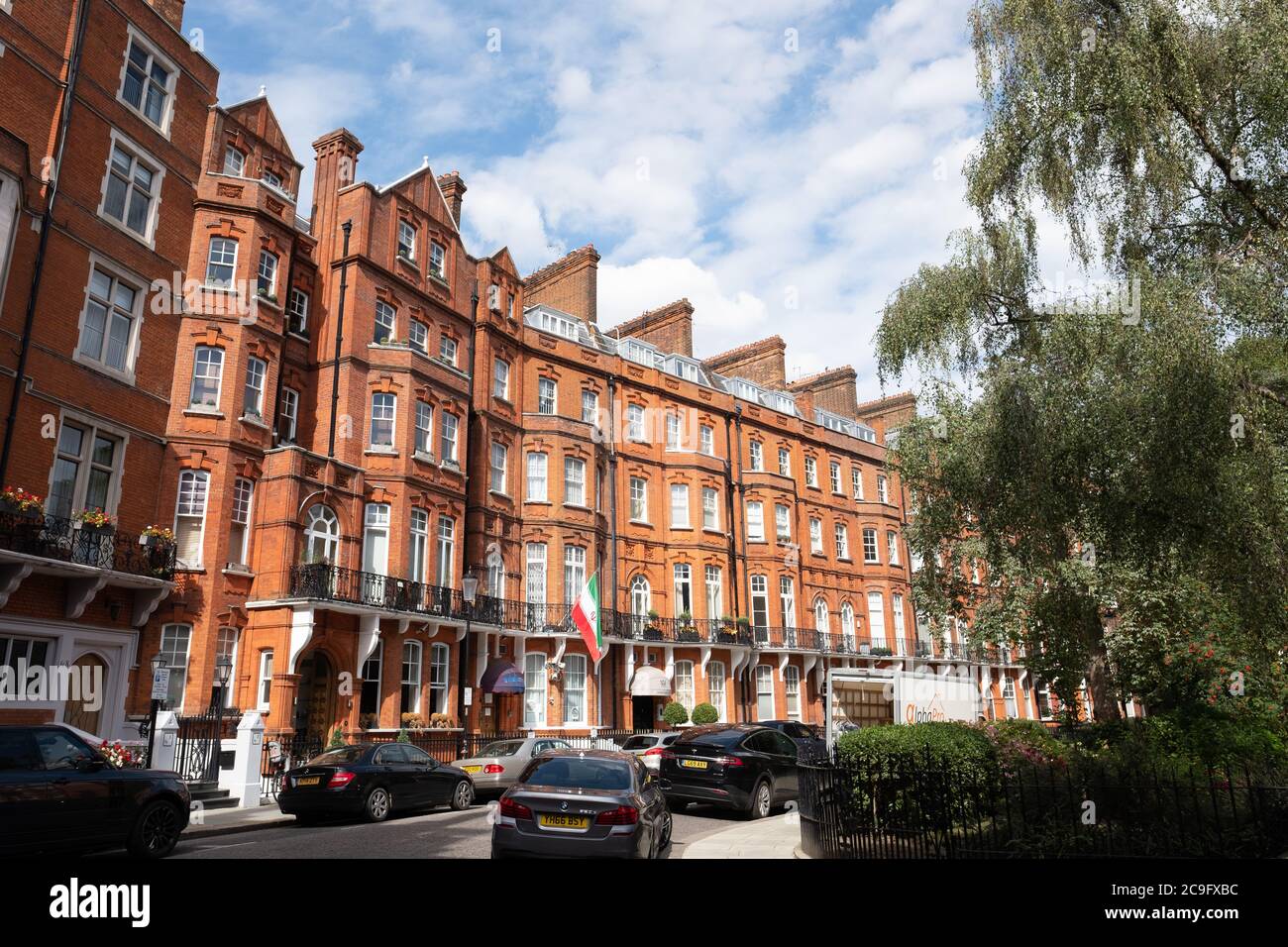 London, July, 2020: Residential street of beautiful red brick terraced London townhouses in Kensington Court, west London Stock Photo